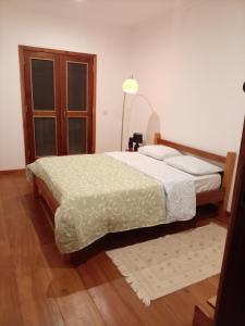 a bedroom with two beds and a lamp at Casa Augusto Stunning view in Trindade
