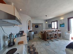 a kitchen and a living room with a table at Dorothea Panoramic Villa in Kampos Paros