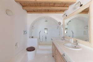 a bathroom with two sinks and a large mirror at Cozy Villa in Mykonos +37 photos