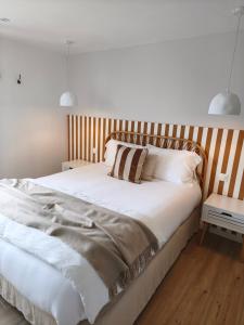 a bedroom with a large bed with a wooden headboard at Au coucher du lac in Publier