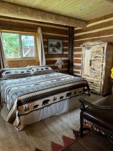 a bedroom with a bed in a log cabin at Homer Spit View Cabins - The Log Cabin in Homer