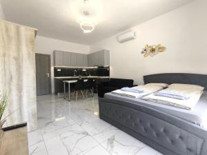 a bedroom with a bed and a dining room at Rael Apartments - free Parking in Katerini