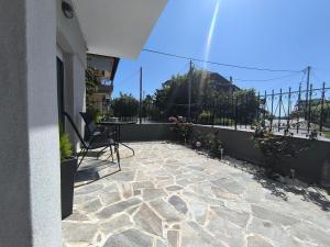 a patio with a table and chairs on a balcony at Rael Apartments - free Parking in Katerini