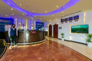 a man standing at a counter in a hotel lobby at منازل الضيف in Jeddah