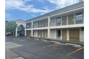 an empty parking lot in front of a building at Studio 6 Suites Louisville KY Airport/Expo Center in Louisville