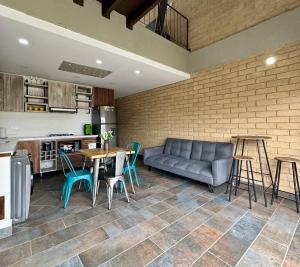 a living room with a couch and a table and chairs at Apartamentos Chia in Chía