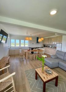 a living room and kitchen with a couch and a table at Sol Dorado in Ferrero