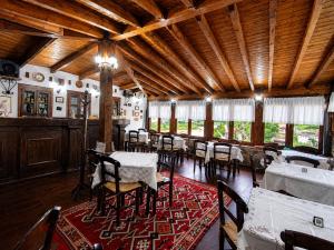 a dining room with tables and chairs in a building at Guva Mangalem Boutique Hotel & Restaurant -Berat Old Town View in Berat