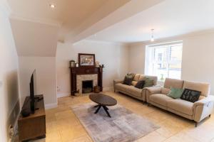 a living room with a couch and a fireplace at The Townhouse in Cahersiveen