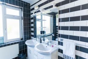 a bathroom with a sink and a mirror at The Townhouse in Cahersiveen +20 photos