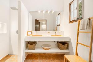 a bathroom with a sink and a mirror at Finca Ses Curtanetas by 3VILLAS in Alaior