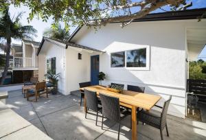a patio with a wooden table and chairs at Dana Point Lantern District Retreat Beach Close in Dana Point