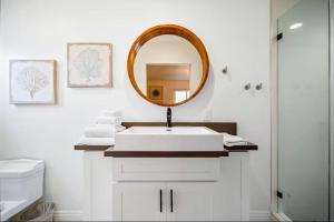 a bathroom with a white sink and a mirror at Dana Point Lantern District Retreat Beach Close in Dana Point +33 photos