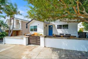 a white house with a blue door at Dana Point Lantern District Retreat Beach Close in Dana Point