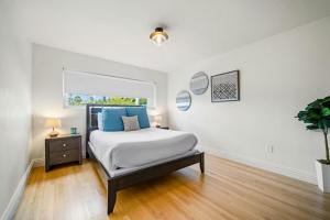 a white bedroom with a bed and a window at Dana Point Lantern District Retreat Beach Close in Dana Point