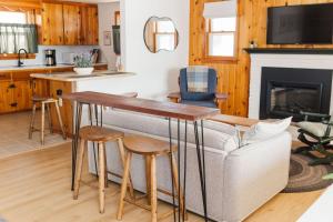 a living room with a couch and a table at Lakefront Retreat Home- Swimming-Fishing-Boating in Bethlehem +30 photos