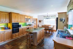 a kitchen with wooden cabinets and a dining room at Tri Phailme in Waterville