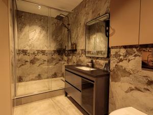 a bathroom with a sink and a shower at EUROPA Hotel in Semey