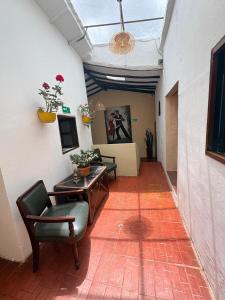 a living room with a couch and a table and chairs at Hotel Alma Divina in Villa de Leyva +10 photos