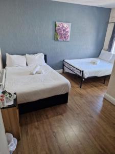 a hotel room with two beds and a table at South Cliff Hotel in Blackpool +30 photos