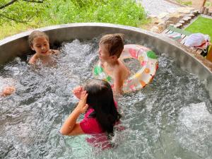 a group of children playing in a swimming pool at Holiday Raj in Bešeňová