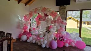 a display of pink and white balloons in a room at Casa Maya in Săsciori +96 photos