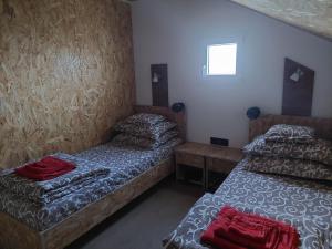 a room with two beds and a window at DOBRA GAZDA - transit sleep in Dobra +15 photos