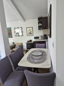 a living room with a table and purple chairs at Guest house Duletic in Budva