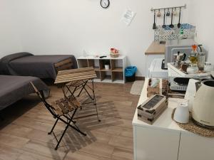a living room with a bed and a kitchen at BALO'S HOUSE in Bari