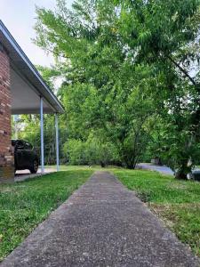 a driveway in front of a house with a car at Bright & Spacious 1BR - UoM Area in Memphis