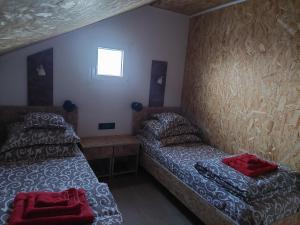 a room with two beds and a couch in it at DOBRA GAZDA - transit sleep in Dobra
