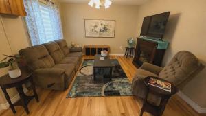 a living room with a couch and a table at spacious three bedroom apartment in Bras D'or