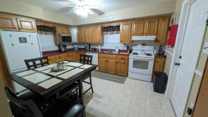 a kitchen with wooden cabinets and a table with chairs at spacious three bedroom apartment in Bras D'or