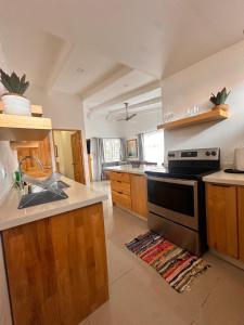 a kitchen with a sink and a stove top oven at Villa Paradise in Jacó