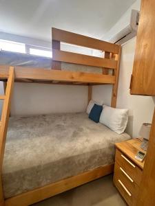 a bedroom with two bunk beds and a desk at Villa Paradise in Jacó