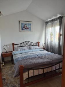 a bedroom with a bed with a wooden head board at Guest house Duletic in Budva +11 photos