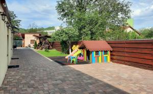 a small playground with a slide and a play house at Casa SOL in Turda