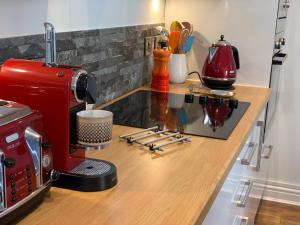 a red coffee maker on a counter in a kitchen at Artists Cottages Artists Loft near Hornbeam Park Free Parking in Harrogate