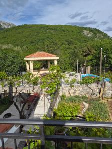 a garden with a gazebo and a house at Guest house Duletic in Budva