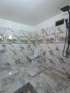 a dirty bathroom with a toilet and a sink at Toubkal Guesthouse in Imlil +29 photos