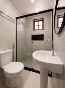 a bathroom with a toilet and a sink and a shower at Brisamar Suítes Ilha Grande in Angra dos Reis +43 photos
