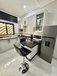 a kitchen with a chair in the middle of it at Black-Oak Apartments in Lusaka