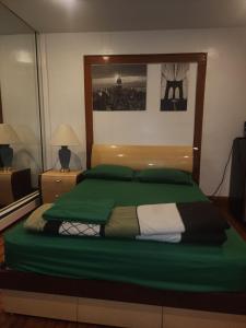 a bedroom with a bed with a green comforter at Sensational in Elizabeth