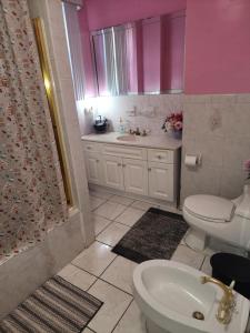 a bathroom with a toilet and a sink at Sensational in Elizabeth