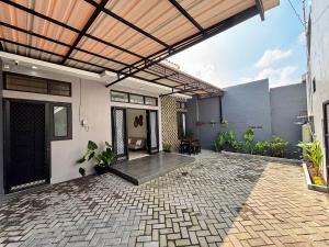an outdoor patio with awning on a house at Secretspot Yogyakarta in Yogyakarta