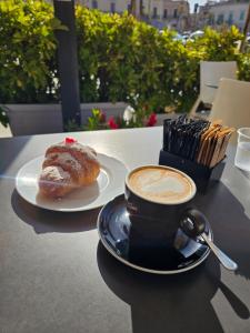 a cup of coffee and a pastry on a table at Maestrale in Giovinazzo +13 photos