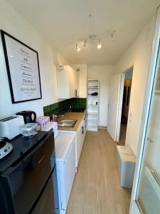 a kitchen with a sink and a counter top at Appartement moderne tout équipé in Évreux