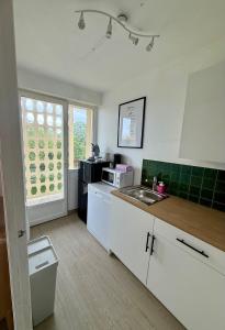 a kitchen with a sink and a counter top at Appartement moderne tout équipé in Évreux