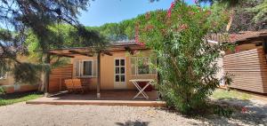 a house with a patio with a table and chairs at Bungalow comfort home in Premantura