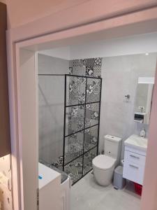 a bathroom with a toilet and a sink at apartment Himara SkyView in Himare